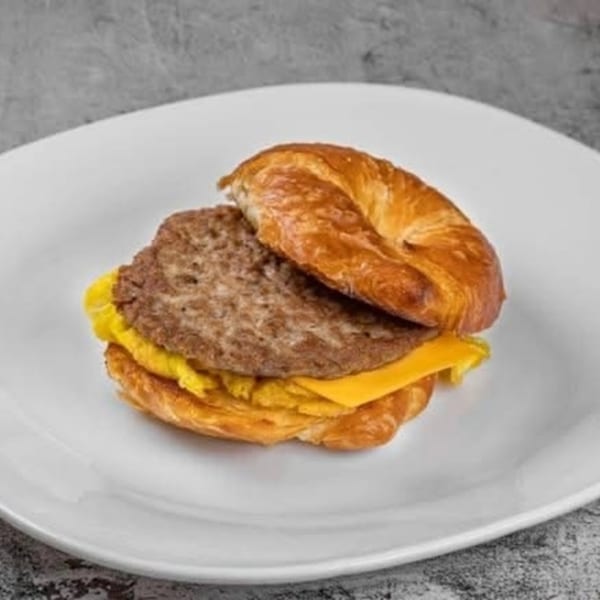 Dat Donut's breakfast sandwich with sausage, egg, and cheese on a croissant.